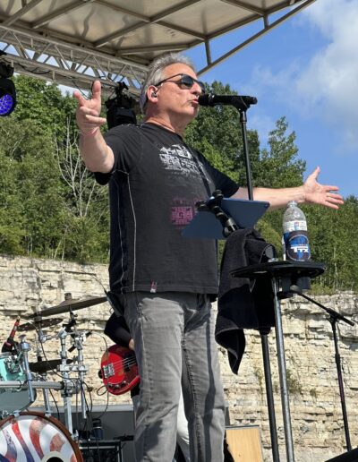 A frontman greeting the crowd from the main stage