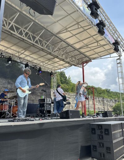 A full band on the main stage with the limestone quarry wall behind