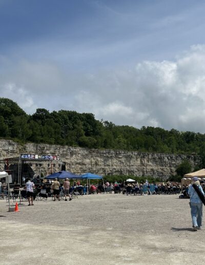 The concert grounds and tents on the quarry floor beneath the limestone wall
